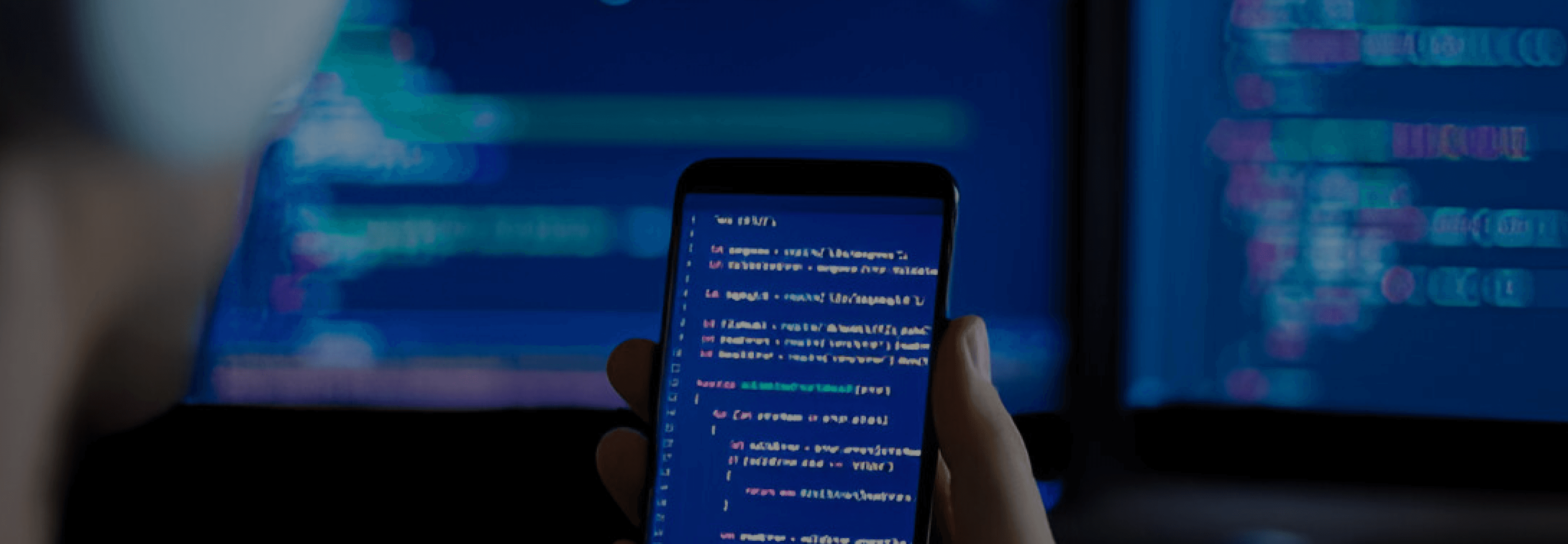 Android mobile phone in hand with code on screen