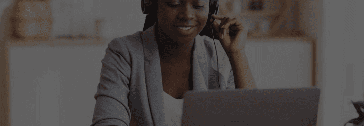 Woman speaking on a computer with headphones on